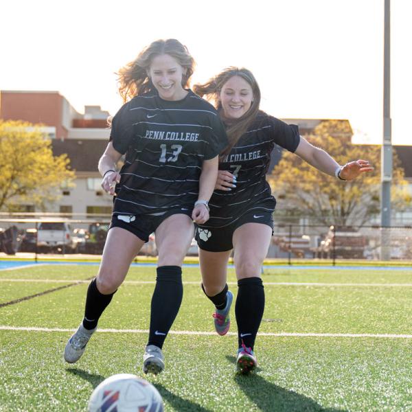 Brooke Klinger (left) is not shy about her love for Penn College, making an impression on sister Sierra.