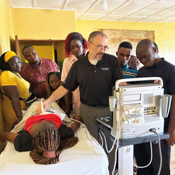 John Zentz, a 1994 Penn College radiography graduate, demonstrates ultrasound equipment to medical professionals at Fayia Medical Clinic in Liberia, where one in 10 women dies of pregnancy complications.