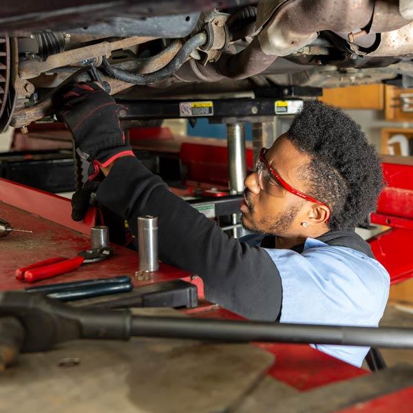 Student working on vehicle