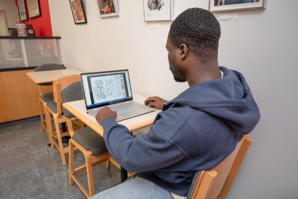 Student using a laptop in Bookmarks Cafe