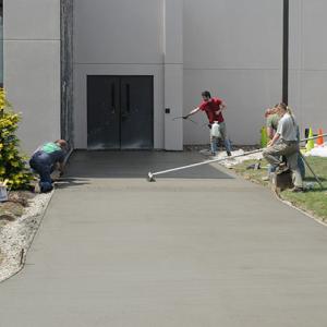 Karstetter (right) watches as finishing touches are applied to another collaborative campus project.