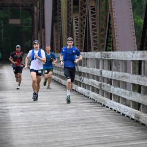 Penn College grad Reagan McCoy runs across a bridge during the Eastern States 100 ultramarathon.