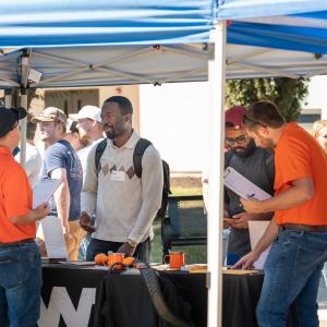 Recruiters talk with students.
