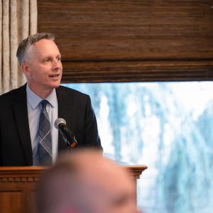 Penn College President Michael J. Reed speaks from behind a podium.