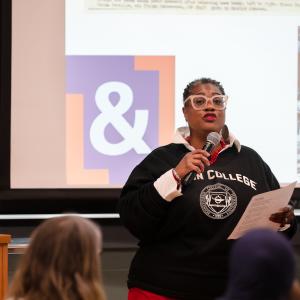 A woman speaks into a microphone.