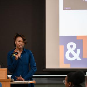A woman speaks into a microphone.