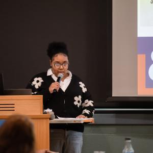 A woman speaks into a microphone.