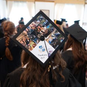 A graduation cap is decorated with photos and says "Thank you, PCT."