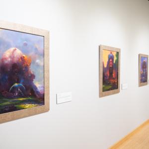 Colorful science fiction paintings by Paul Lehr are displayed in The Gallery at Penn College.