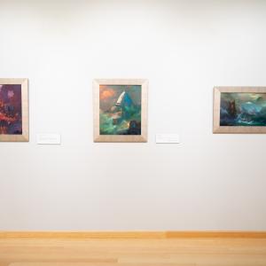 Colorful science fiction paintings by Paul Lehr are displayed in The Gallery at Penn College.