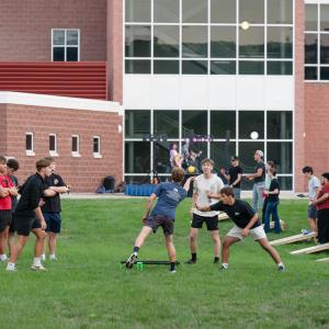 Students play spikeball and other yard games in front of Penn College's Dauphin Hall.