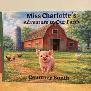 Cover of a children's book titled "Miss Charlotte's Adventure to Our Farm" shows an illustration of a pig with a red barn in the background.