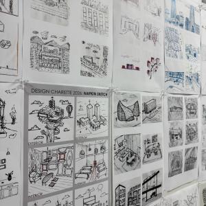A wall is covered by 5-inch-by-five-inch architecture-related sketches.
