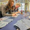 Melinda L. Furman (left) and Betty Anne Leiby, simulation laboratory coordinators, nursing education, sign quilt patches.