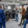 Group talks near automatec manufacturing machine