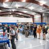 Students gather around information tables in the Penn College Field House.