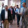 People in business attire chat while walking through Penn College's Davie Jane Gilmour Center. At the front are Pennsylvania Secretary of Transportation Michael Carroll and Penn College President Michael J. Reed.