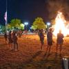 People gather around a giant bonfire on Penn College's Madigan Library lawn.