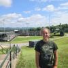 Trinity Willoughby stands on a hill with Lamade Stadium, site of the Little League Baseball World Series, in the background.