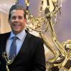 Tom Speicher holds his 2025 Mid-Atlantic Emmy Award.