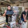 Students smile as they remove tools and equipment from boxes in Penn College's refrigeration labs.