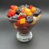 Glass bowl of fresh fruit, including acai berries.
