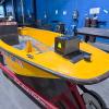 The Montgomera Emergency Managemen Agency's birght yellow rescue boat sits on a trailer in Penn College's welding lab.