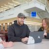 A screenshot from a Milton Hershey School video shows three people conversing in Penn College's Madigan Library.