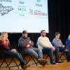 Five people sit on the stage of Penn College’s Klump Academic Center Auditorium. One is speaking into a microphone.