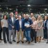 A large group of people poses inside Penn College's Larry A. Ward Machining Technologies Center.