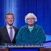 Helen Yoas stands next to "Jeopardy!" host Ken Jennings on the TV show's set.