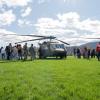 People gather around a Black Hawk helicopter on a Penn College lawn.