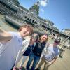 Penn College students and a staff member take a selfie in front of the Pennsylvania Capitol building.
