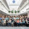 A large group of alumni poses in the atrium of Penn College's Madigan Library.
