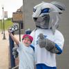 A young fan poses with the Penn College Wildcat. 