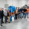 Officials from Pennsylvania College of Technology, Bruderer Machinery Inc. and TE Connectivity surround a mechanical stamping press in the college’s Gene Haas Center for Innovative Manufacturing.
