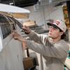 In a Pennsylvania College of Technology heating, ventilation & air conditioning lab, student Marcello A. Santora, of Haskell, New Jersey, services a mini-split indoor unit by removing and inspecting the air filters before cleaning and reinstalling them.