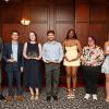Seven students wearing dress clothes and holding glass award trophies pose for a photo with Penn College President Michael J. Reed.