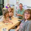 Two adults and two children work together on crafts in a preschool classroom at Penn College's Dunham Children's Learning Center.