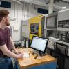 Drake J. McGregor, a polymer engineering technology student from Waynesboro, monitors mold cavity pressure while operating an injection molding machine at Pennsylvania College of Technology’s Gene Haas Center for Innovative Manufacturing.