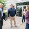 President Michael J. Reed and state Sen. Scott Martin chat with a student outside the college's Davie Jane Gilmour Center..