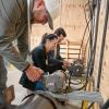 In a Penn College electrical lab, visiting educators wire a three-phase motor.