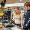 Two students enter their food order on a kiosk at Penn College's CC Commons dining unit.
