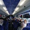 A bus full of passengers traveling to an event.