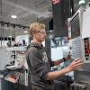 A student operating a CNC (Computer Numerical Control) machining center in Penn College’s Gene Haas Center for Innovative Manufacturing.