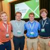 Four Penn College students pose in a conference room. A large projection screen behind them reads "SPE Blow Molding: 2026 Student Design Presentations." 