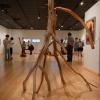 A sculpture created by late science-fiction artist Paul Lehr is displayed in the Gallery at Penn College. In the background, people view other works by the artist.