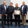 Pennsylvania College of Technology Police Lt. David C. Pletz (holding plaque) has received national recognition for actions leading to the Sept. 28 apprehension of an armed suspect near campus. Among those on hand at an awards ceremony are (from left) Penn College President Michael J. Reed; Penn College Police Chief Chris E. Miller; and Elliott Strickland, vice president for student affairs. 
