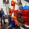 Penn College welding technology students Ryan D. Nichol, of Oxford, and Ellissa R. Kunkel, of Kempton, work with a CLOOS robot and controller in the college’s welding lab.