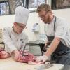 Chef Lance Smith, executive chef of The Millworks in Harrisburg and a 2006 Pennsylvania College of Technology graduate, returned to the college to guide culinary arts students, including Dallas A. Tyree, of Stillwater, left, in butchering hogs and making hams, bratwursts and other products.
